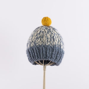 Hand-knitted bulky pompom beanie in Blue x Yellow