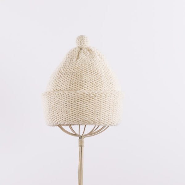 Purl stitch beanie with crocheted mini pompom in Natural