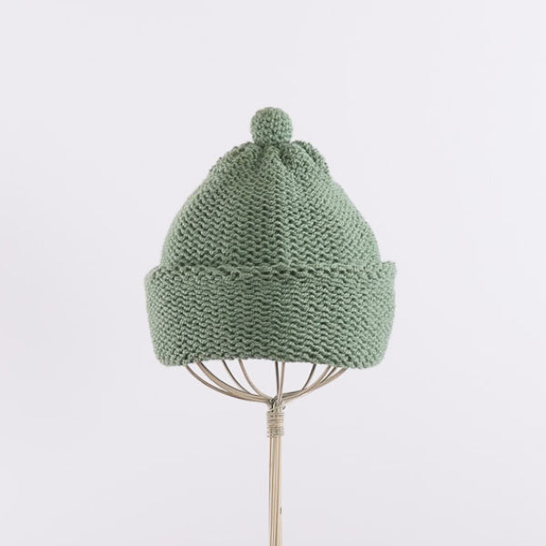 Purl stitch beanie with crocheted mini pompom in Sage